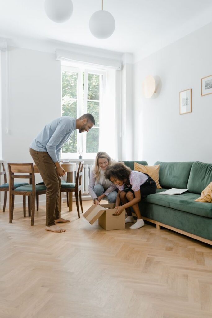 Happy family unboxing together in a bright living room, capturing joy and togetherness.